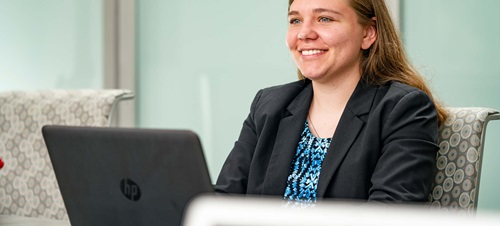  Female in Professional Wear Sitting in Front of Laptop.