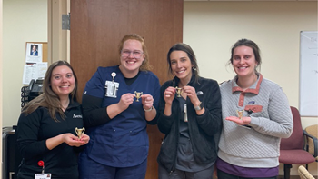 Four medical students stand together for a photo.