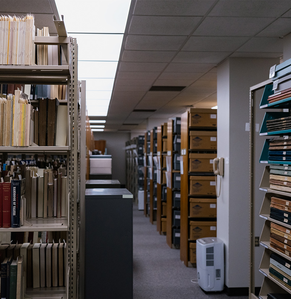 A room filled with shelves with old books and old picture frames