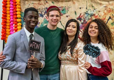 Students Holding Signs in Photo Booth at Festival of Nations