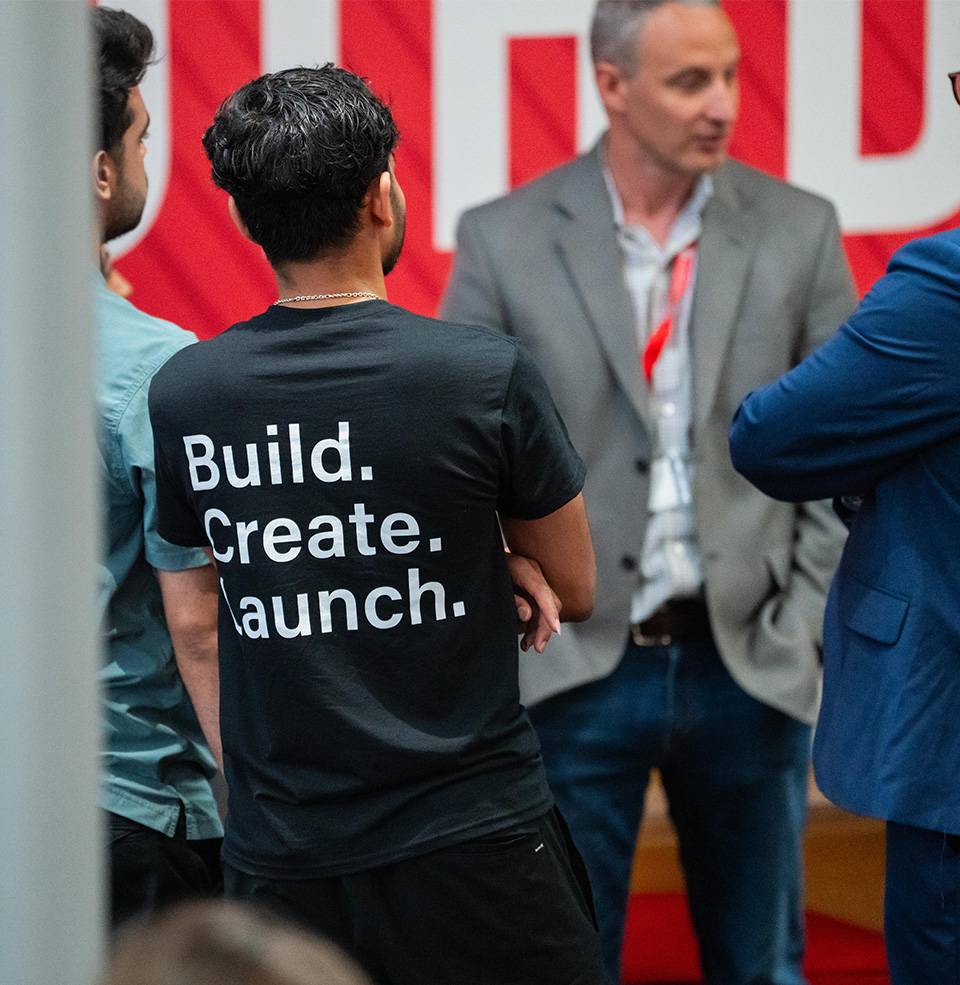 The back of a t-shirt that says build. create. launch.