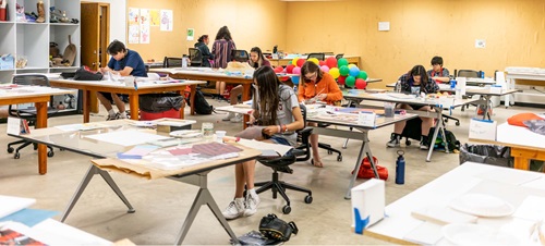 Students in the Oscar Howe art center creating work.