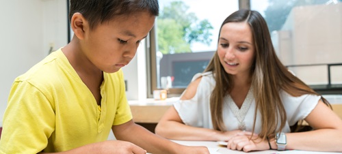 Child in speech therapy with therapist.