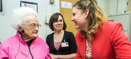 Elderly woman with speech therapist.