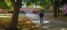 The Academic Commons path with a student moving towards it.