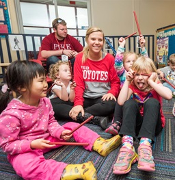 two USD Students playing with preschool students