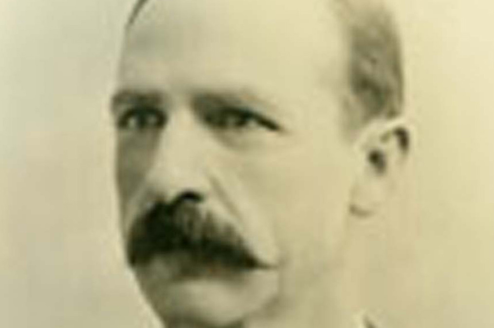 Former USD President Edward Olson smiling.