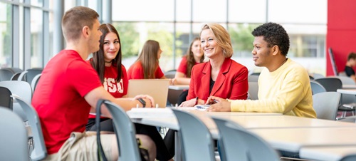 President Gestring Sitting with Students.