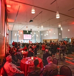 The Live Your Legacy alumni event in the MUC ballroom with alumni sitting around tables during a large conference.