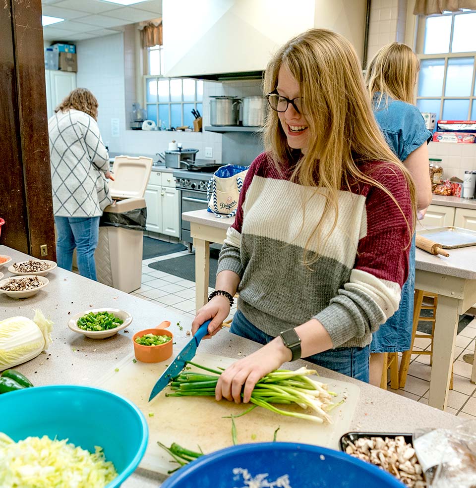 A student cutting food.