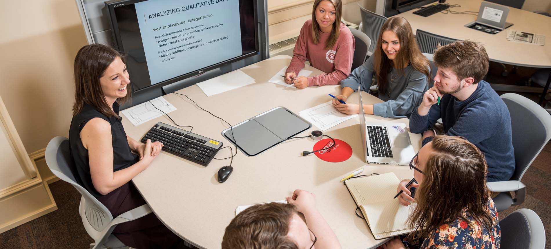 Instructor students discussion table video screen
