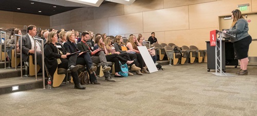 Student Presenting in Front of a Crowd.