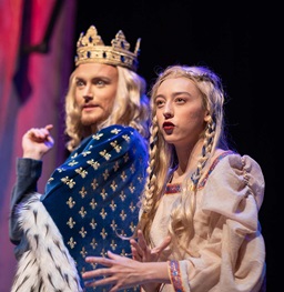 Students perform play on stage.