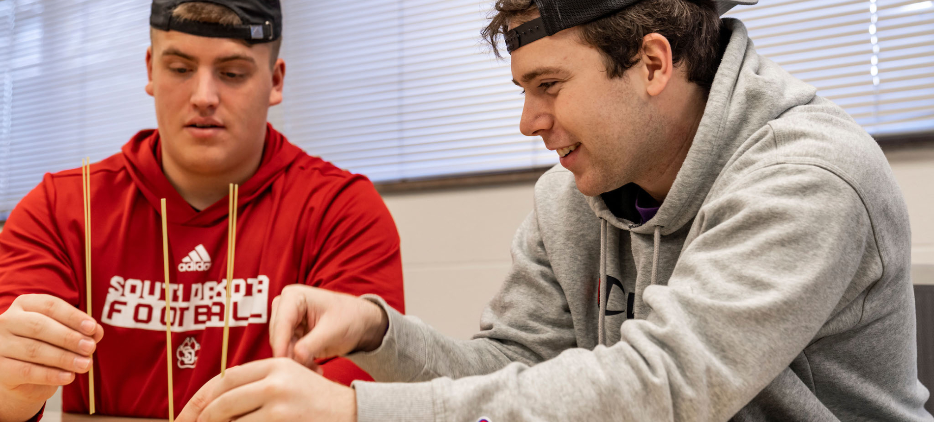 Two Education male students working on a classroom project.