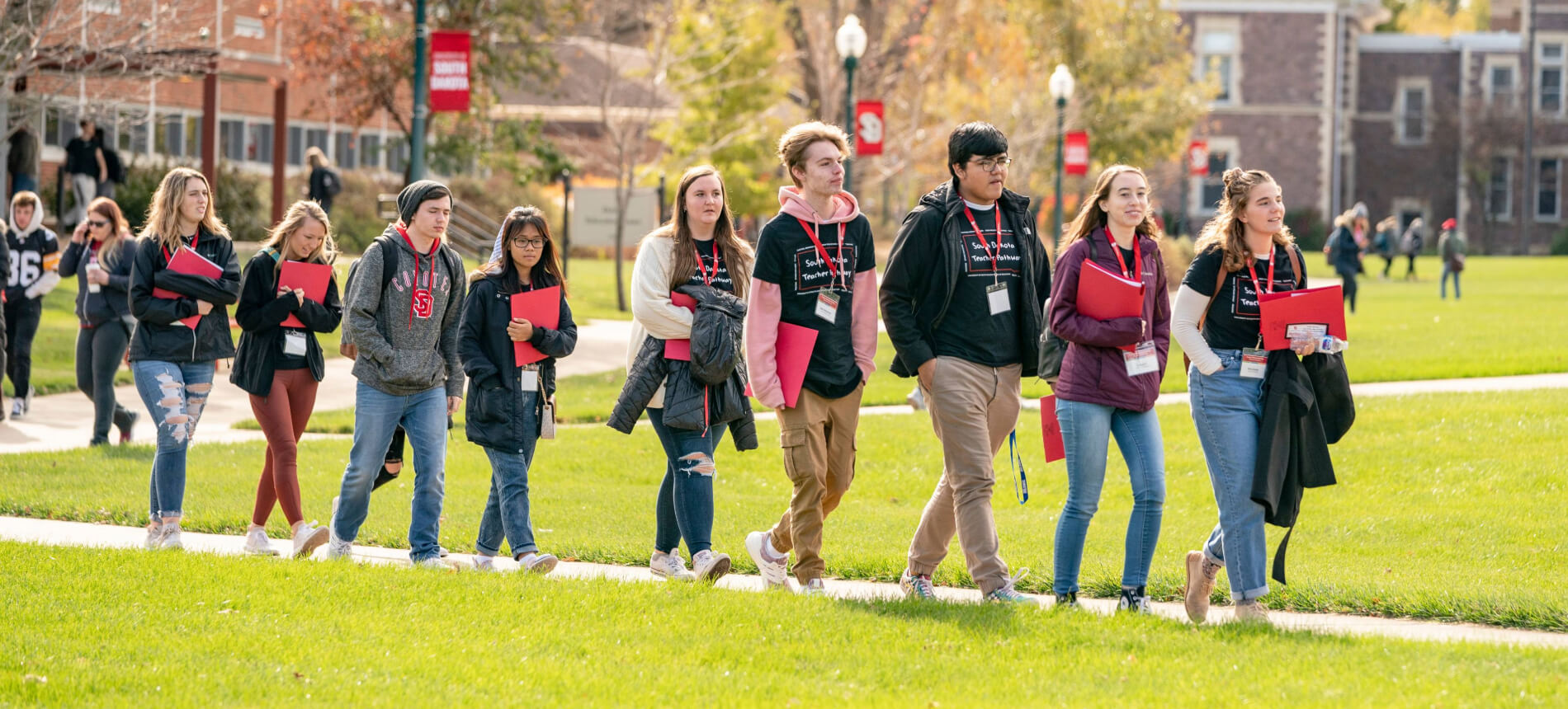 High school students walking on campus during a school of ed event.