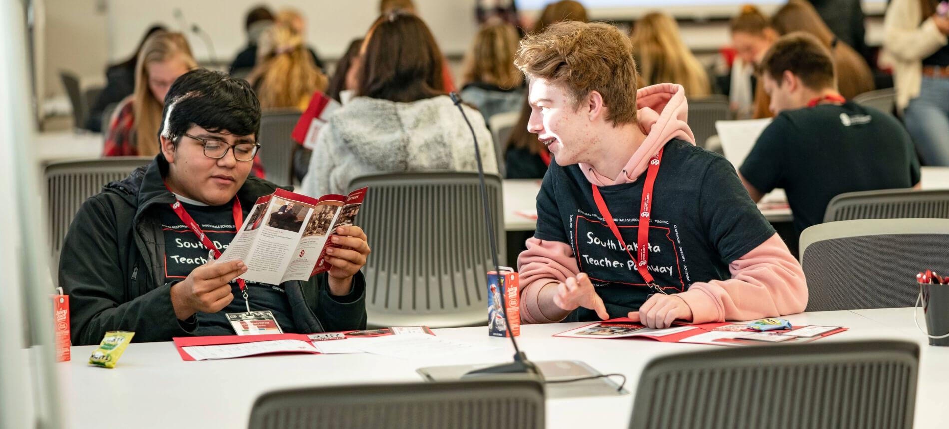 Students smiling during a school of ed event.