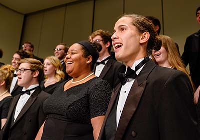 Students singing together in choir.