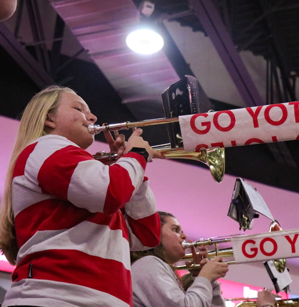 The Coyote pep band playing at a basketball game.