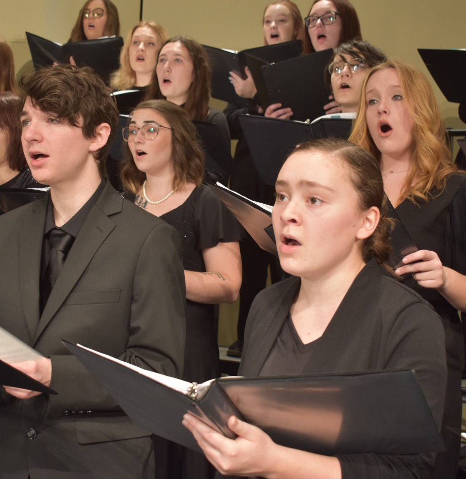 The USD symphonic choir singing on stage.