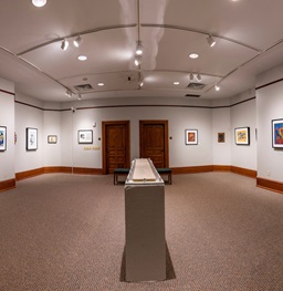 An empty Oscar Howe Art Gallery with art on the walls.