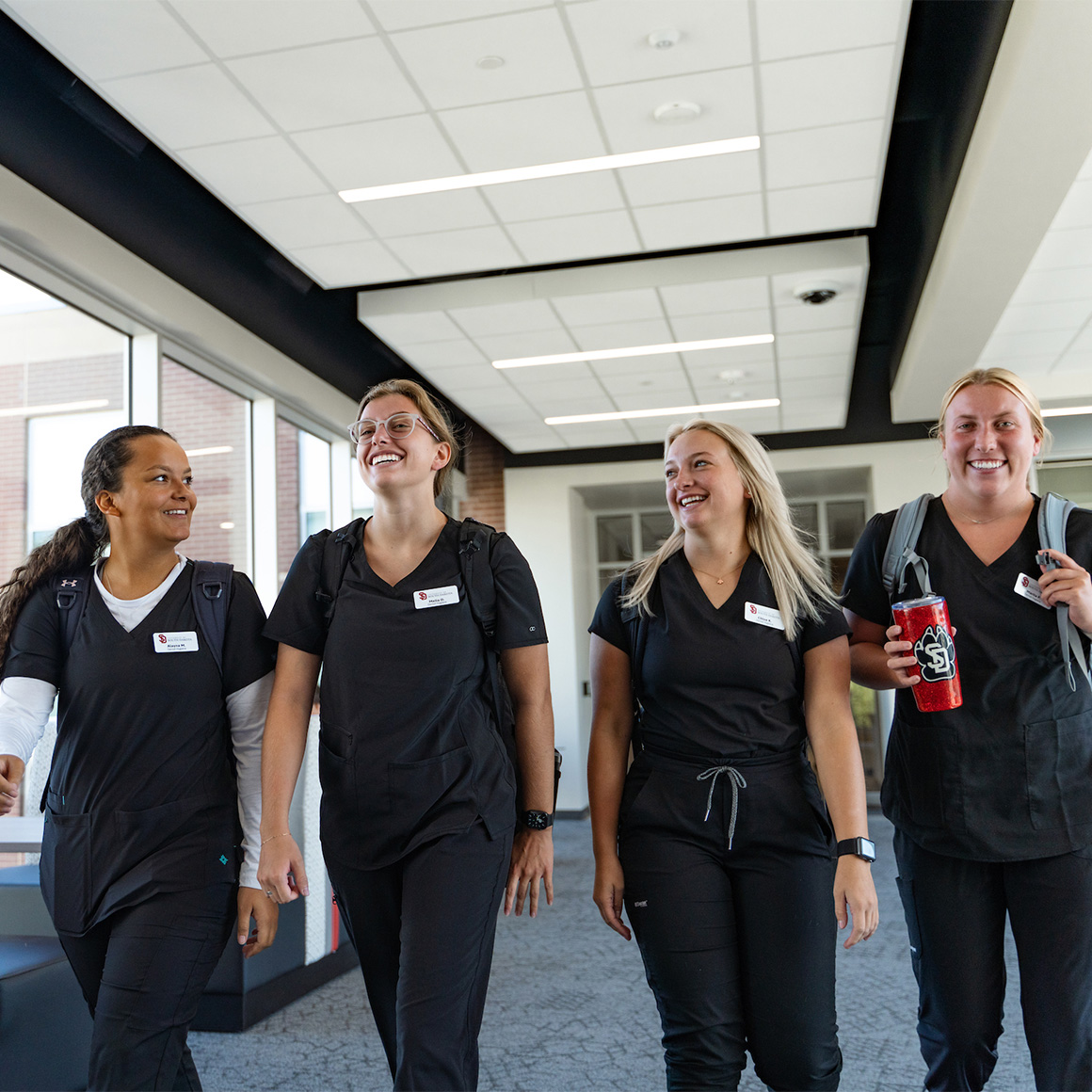 Health sciences students walking down the hallway.