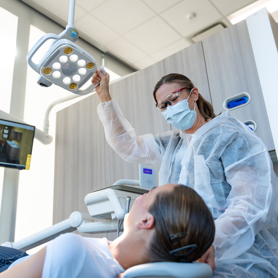 A dental hygienist working on a patient.