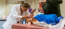 Physician Assistant Student Inserting a Tube in a Dummy