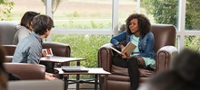 A counselor working with two students.