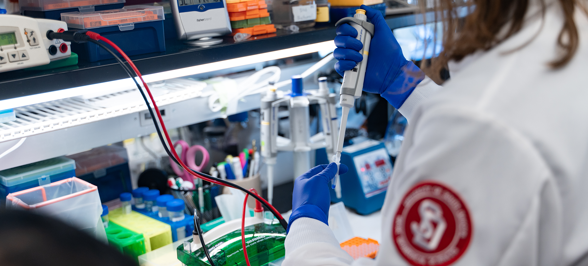 USD student researcher working with lab equipment