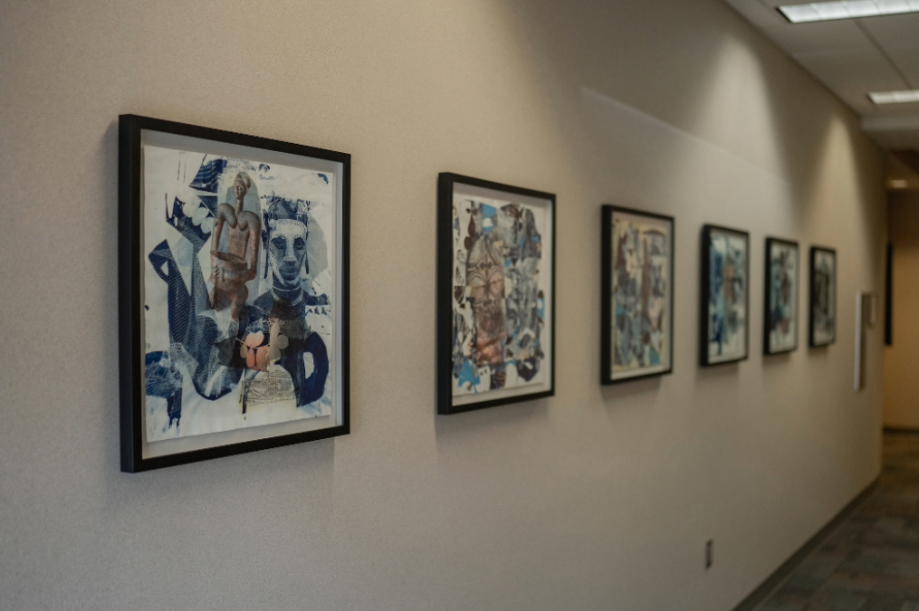 Student paintings hanging on the wall in the Parry Center's Arts in Medicine Gallery.