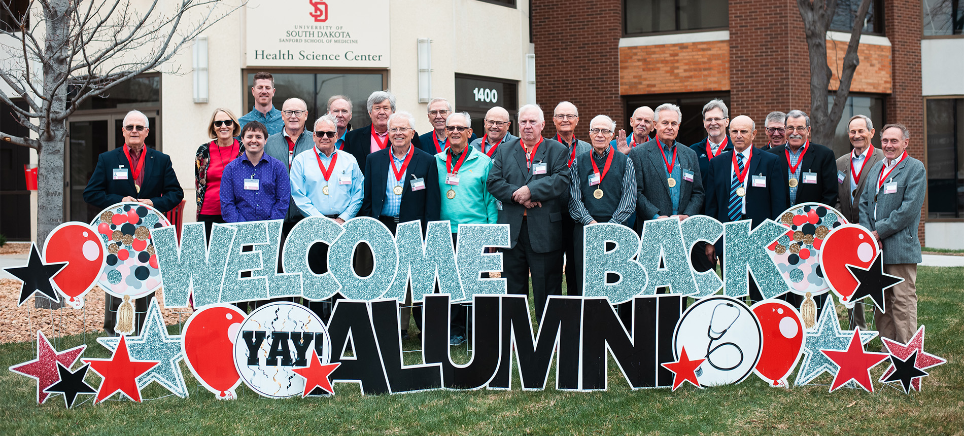 School of Medicine alumni smiling for a photo.