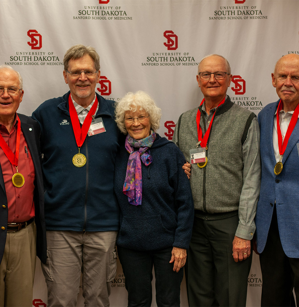 Sanford School of Medicine Alumni posing and smiling for a picture.