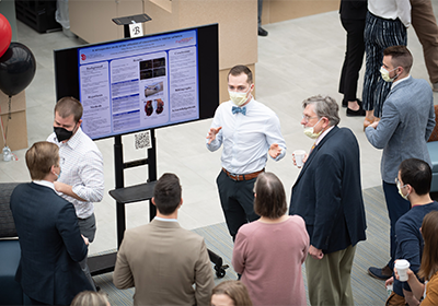 A student presenting at scholar's day.