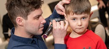 A doctor inspecting a child's ear.