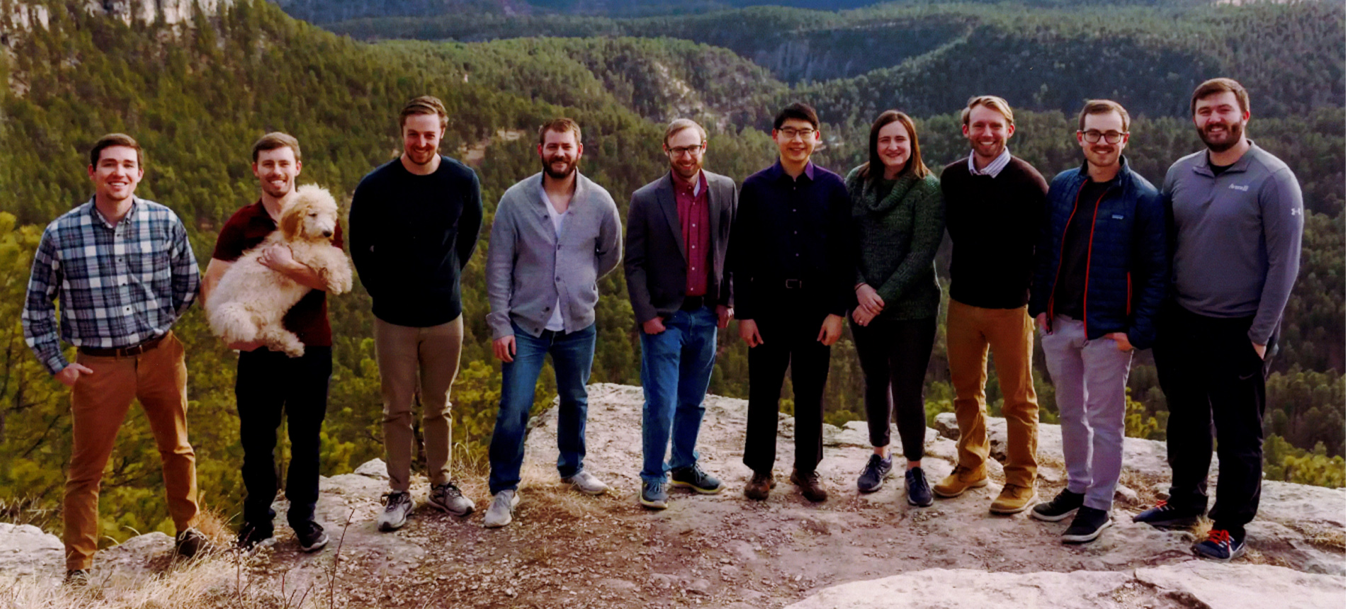 Medical faculty of the Rapid City campus posing for a picture on a mountain.