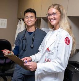 Two USD Medicine students smiling at the camera.