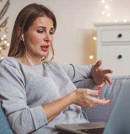 A student in a meeting on her laptop at home.