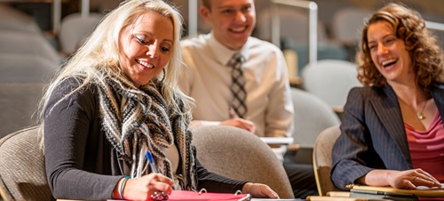 Three faculty of Communications talking and laughing