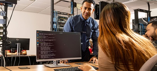 Students working with professor KC Santosh in the state-of-the art computer labs at USD.