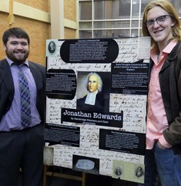 Two students with history poster.