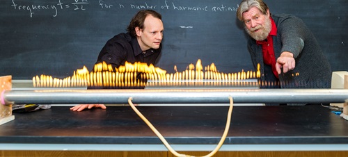 Student and professor in class playing with fire