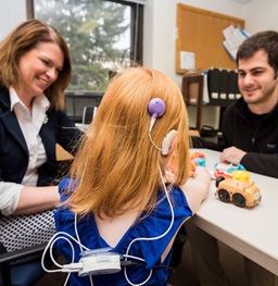 A child and two adults playing with health equipment together.
