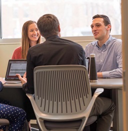 Group of Students Sitting Around a Table Talking.