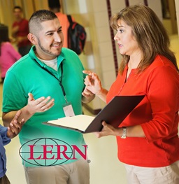 Teacher prepares in the hallway with school leadership.