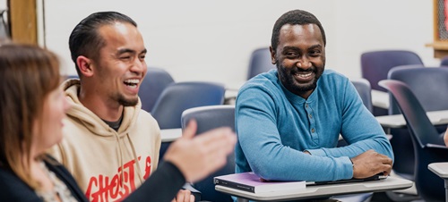 Students laughing and smiling during class.