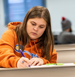 A girl writing in her notebook.
