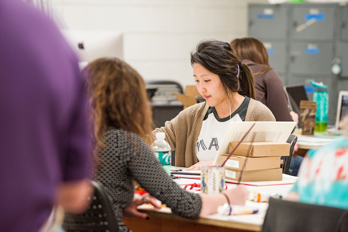 Art class with students painting at desks
