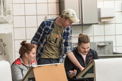 Students painting in a gallery.