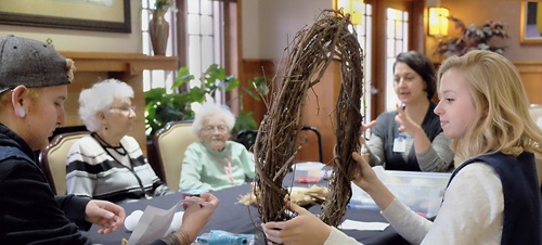 A group of people sitting around a table talking.