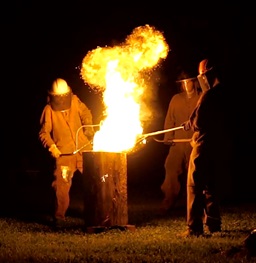 Students Pour hot iron with ladle into molds at the Little Pour on the Prairie